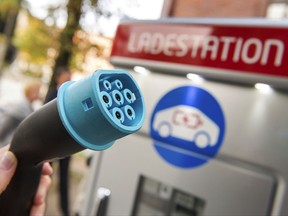 FILE - In this Wednesday, Oct. 18, 2017 photo a plug is shown at a charging station for electric vehicles in Hamburg, Germany. Major automakers say their joint European electric car recharging network will open its first stations this year in Germany, Austria and Norway in what the companies hope will be a big step toward mass acceptance of battery-powered cars. (Daniel Bockwoldt/dpa via AP, File)