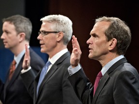 Kent Walker, vice president and general counsel with Google Inc., from right, Colin Stretch, general counsel with Facebook Inc., and Sean Edgett, acting general counsel with Twitter Inc., swear in to a House Intelligence Committee hearing in Washington, D.C., U.S., on Wednesday, Nov. 1, 2017. The top Democrat on the Senate Intelligence Committee berated lawyers today for social media giants Facebook, Twitter and Google for a lethargic response to Russian interference in U.S. politics, as the companies' lawyers faced a second day of grilling in Congress.