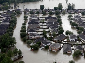 Homes are surrounded by floodwaters from Tropical Storm Harvey in Spring, Texas this August.