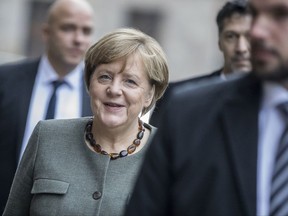 German Chancellor Angela Merkel smiles as she arrives for talks about a potential coalition between her Christian Democrats, the Free Democratic party FDP and the Greens in Berlin Friday, Nov. 20, 2017. (Michael Kappeler/dpa via AP)