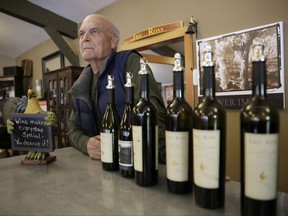 In this photo taken Monday, Oct. 30, 2017, winemaker Eric Luse stands behind the tasting room counter at his Eric Ross Winery in Glen Ellen, Calif. Once people understand everything is not burned down, tourism will return within a few months, said Luse. "If you're not optimistic, you are in the wrong business." (AP Photo/Eric Risberg)