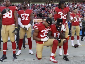 San Francisco 49ers safety Eric Reid (35) and wide receiver Marquise Goodwin (11) kneel during the performance of the national anthem before an NFL football game against the New York Giants in Santa Clara, Calif., Sunday, Nov. 12, 2017. (AP Photo/Marcio Jose Sanchez)