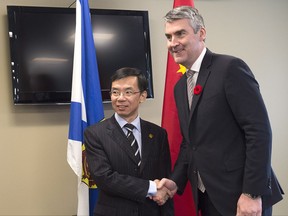 Nova Scotia Premier Stephen McNeil, right, and Lu Shaye, Ambassador of the People's Republic of China to Canada, pose for photos after a bilateral meeting in Halifax on Tuesday, Nov. 7, 2017. THE CANADIAN PRESS/Andrew Vaughan