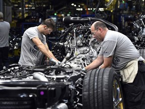 In this Friday, Oct. 27, 2017, photo, workers assemble Ford trucks at the Ford Kentucky Truck Plant in Louisville, Ky. On Thursday, Nov. 16, 2017, the Federal Reserve reports on U.S. industrial production for October. (AP Photo/Timothy D. Easley)
