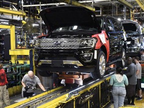 In this Friday, Oct. 27, 2017, photo, workers assemble Ford trucks at the Ford Kentucky Truck Plant in Louisville, Ky. On Friday, Nov. 3, 2017, the Commerce Department reports on U.S. factory orders for September. (AP Photo/Timothy D. Easley)