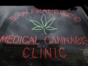FILE - This Oct. 19, 2009 file photo shows a neon sign at the entrance to the San Francisco Medical Cannabis Clinic in San Francisco. San Francisco supervisors plan to take up recreational pot regulations Tuesday, Nov. 14, 2017, a process that has taken a surprisingly contentious turn in the weed-friendly city as critics, who are largely Chinese American and immigrant, have lobbied against placing retail shops too close to children. (AP Photo/Eric Risberg, File)