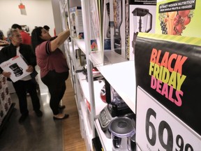 Thanksgiving holiday shoppers check out the bargains at the JCPenny store in Glendale, Calif., Thursday, Nov. 23, 2017. Shoppers are hitting the stores on Thanksgiving as retailers under pressure look for ways to poach shoppers from their rivals. As the holiday shopping season officially kicked off, retailers are counting on a lift from a better economy. (AP Photo/Richard Vogel)