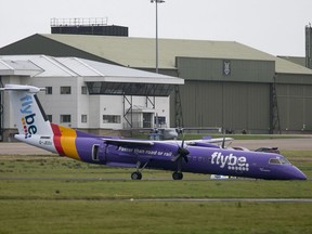 A Flybe plane on the tarmac at Belfast International Airport, in Northern Ireland, Friday Nov. 10, 2017.  The plane carrying more than 50 people made an emergency landing without its nose gear at Belfast International Airport. (Liam McBurney/PA via AP)