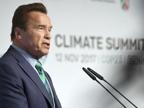 Former governor of California Arnold Schwarzenegger talks in the "Bonn-Zone" during the World Climate Conference in Bonn, Germany, Sunday Nov. 12, 2017.  During the summit, cities and regions emphasize that climate protection is not only an issue for national governments. (Henning Kaiser/dpa via AP)