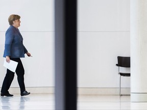 German Chancellor Angela Merkel walking in the Bundestag after a further round of the ongoing exploratory talks by the Christian bloc CDU/CSU, the Free Democrats, FDP and The Green Party  in Berlin, Germany,  Tuesday, Nov. 7, 2017. (Silas Stein/dpa via AP)