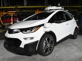 FILE - In this Tuesday, June 13, 2017, file photo, a self-driving Chevrolet Bolt EV that is in General Motors Co.'s autonomous vehicle development program appears on display at GM's Orion Assembly in Lake Orion, Mich. General Motors expects to have autonomous vehicles working commercially in big cities sometime in 2019. The company made the prediction Thursday, Nov. 30, 2017, in slides posted on its website ahead of an investor presentation. (Jose Juarez/Detroit News via AP, File)