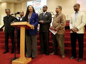 The Rev. Dinah Tatman, center, with Greater New Vision Ministries, Inc., announces details of a new economic boycott flanked other clergy members looking on Thursday, Nov. 2, 2017 in St. Louis, Mo. Tatman said African-Americans are subjected to excessive force by police, criminalized for minor infractions and saddled with long sentences. She also cited economic disparities, efforts to diminish voting rights and political redistricting that has made it harder for black people to have their voices heard.   (Christian Gooden/St. Louis Post-Dispatch via AP)