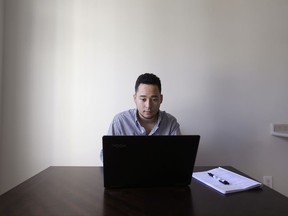 In this Thursday, Oct. 19, 2017, photo, freelancer Jaimyn Chang works in his home office in Raleigh, N.C. Chang does search engine optimization work for small businesses and now requires a credit card number up front to do work because of the many times people didn't pay. (AP Photo/Gerry Broome)