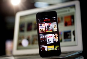 The Netflix app is displayed on an Apple iPhone