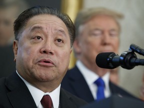 FILE - In this Thursday, Nov. 2, 2017, file photo, Broadcom CEO Hock Tan speaks as President Donald Trump listens during an event to announce the company is moving its global headquarters to the United States, in the Oval Office of the White House, in Washington. Broadcom is making an unsolicited, $130 billion offer for rival chipmaker Qualcomm. (AP Photo/Evan Vucci, File)