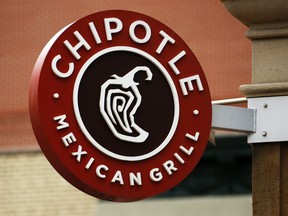 FILE - In this Jan. 12, 2017, file photo, a Chipotle restaurant sign hangs in Pittsburgh. Chipotle says it is looking for a new CEO. Its founder, Steve Ells, who currently serves as CEO and chairman, will become executive chairman once someone new is in place at the top post. (AP Photo/Gene J. Puskar, File)
