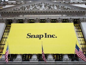 FILE - In this Thursday, March 2, 2017, file photo, a banner for Snap Inc. hangs from the front of the New York Stock Exchange, in New York. Chinese internet company Tencent buys a 10 percent stake in Snap, announced Wednesday, Nov. 8, 2017.  (AP Photo/Mark Lennihan, File)