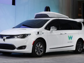 FILE - In this Sunday, Jan. 8, 2017, file photo, a Chrysler Pacifica hybrid outfitted with Waymo's suite of sensors and radar is displayed at the North American International Auto Show in Detroit. Google is partnering with AutoNation, the country's largest auto dealership chain, in its push to build a self-driving car. AutoNation said Thursday, Nov. 2, that its dealerships will provide maintenance and repairs for Waymo's self-driving fleet of Chrysler Pacifica vehicles. (AP Photo/Paul Sancya, File)