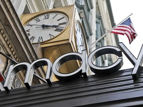 This Tuesday, May 2, 2017, photo shows corporate signage at Macy's flagship store in Manhattan, in New York. Macy's Inc. reports earnings Thursday, Nov. 9, 2017. (AP Photo/Bebeto Matthews)