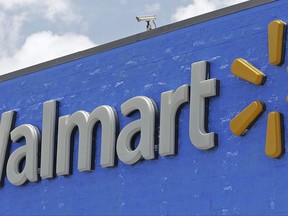 FILE - This Thursday, June 1, 2017, file photo, shows a Walmart sign at a store in Hialeah Gardens, Fla. Walmart announced Monday, Nov. 13, 2017, that it will devote a section on its website to upscale Lord & Taylor, the latest strategic partnership as retailers make alliances. (AP Photo/Alan Diaz, File)