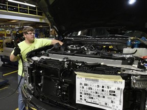 In this Friday, Oct. 27, 2017, photo, a worker helps assemble a Ford truck at the Ford Kentucky Truck Plant, in Louisville, Ky. On Tuesday, Nov. 14, 2017, the  Labor Department reports on U.S. producer price inflation in October. (AP Photo/Timothy D. Easley)