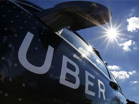 FILE - In this Monday, Sept. 12, 2016, file photo, a self-driving Uber sits ready to take journalists for a ride during a media preview in Pittsburgh. A federal criminal investigation into alleged espionage at Uber has indefinitely delayed a trial over whether the beleaguered ride-hailing service stole self-driving car technology from Waymo, a spinoff from Google. (AP Photo/Gene J. Puskar, File)