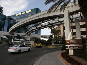 FILE - In this Jan. 14, 2016, photo, cars drive into the MGM Grand hotel and casino in Las Vegas. MGM Resorts International reports earnings, Wednesday, Nov. 8, 2017. (AP Photo/John Locher, File)