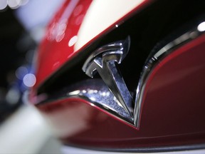 FILE - This Friday, Sept. 30, 2016, file photo shows the logo of the Tesla Model S on display at the Paris Auto Show in Paris. Tesla Inc. reports earnings Wednesday, Nov. 1, 2017. (AP Photo/Christophe Ena, File)