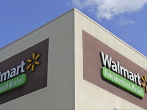 FILE - This Wednesday, Feb. 8, 2017, file photo shows Walmart signage at one of the company's neighborhood markets in Hialeah, Fla. Wal-Mart Stores, Inc. reports earnings, Thursday, Nov. 16, 2017. (AP Photo/Alan Diaz, File)