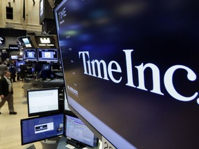 FILE - In this Thursday, June 15, 2017, file photo, the Time Inc. logo appears above a trading post on the floor of the New York Stock Exchange. Time Inc. is considering a sale to fellow publisher Meredith Corp., according to media reports, Thursday, Nov. 16, 2017. Time and Meredith both declined comment on the reports. (AP Photo/Richard Drew, File)