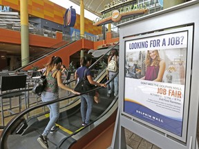 FILE - In this Tuesday, Oct. 3, 2017, file photo, people head to at a job fair at Dolphin Mall in Sweetwater, Fla. On Thursday, Nov. 30, 2017, the Labor Department reports on the number of people who applied for unemployment benefits a week earlier. (AP Photo/Alan Diaz, File)