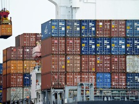 FILE - In this Aug. 5, 2010, file photo, a container is loaded onto a cargo ship at the Tianjin port in China. The United States is joining a fight against China at the World Trade Organization in a decision likely to ratchet up tensions between Washington and Beijing. The U.S. is supporting the European Union in a dispute over China's status at the WTO. The United States and EU contend that the Chinese government continues to interfere so heavily in the country's commerce that China remains a "non-market'' economy. (AP Photo/Andy Wong, File)