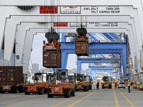 In this Oct. 24, 2016, photo, containers are unloaded from a ship at the Port of Baltimore. On Friday, Nov. 3, 2017, the Commerce Department reports on the U.S. trade gap for September. (AP Photo/Patrick Semansky)