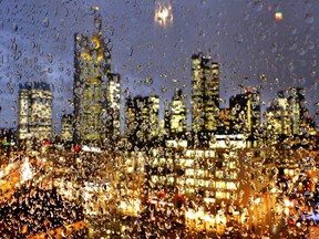 2017 AP YEAR END PHOTOS - The buildings of the banking district are seen through rain drops on a glass railing in central Frankfurt, Germany, on Jan. 11, 2017. (AP Photo/Michael Probst)
