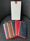 The OnePlus 5T retail box as well as an assortment of cases for the smartphone.