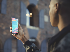 The OnePlus 5T being held by a user.