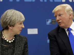 FILE - In this May 25, 2017, file photo, U.S. President Donald Trump, right, speaks to British Prime Minister Theresa May during in a working dinner meeting at the NATO headquarters during a NATO summit of heads of state and government in Brussels. Trump initially responded to May's criticism of his retweeting of inflammatory anti-Muslim videos from a fringe British political group by directing his message to the wrong Theresa May on Twitter Nov. 29, 2017 . (AP Photo/Matt Dunham, Pool, File)