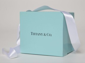 FILE - In this May 22, 2017, file photo, a gift box from Tiffany & Co. is arranged for a photo in Surfside, Fla. The New York-based jewelry chain opened a restaurant on Friday, Nov. 10, 2017, at its flagship 5th Ave. location in Manhattan and the menu does include breakfast. (AP Photo/Wilfredo Lee, File)