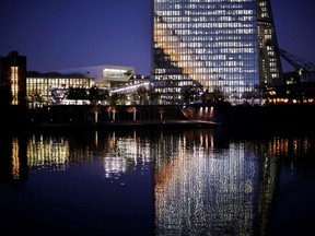 The bottom part of the European Central Bank is reflected in the Main river in Frankfurt, Germany, Wednesday, Nov. 22, 2017. (AP Photo/Michael Probst)
