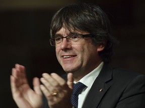 Ousted Catalan leader Carles Puigdemont applauds Catalan mayors who travelled to Brussels to take part in an event in support of the ousted Catalan government in Brussels, Belgium on Tuesday, Nov. 7, 2017. Puigdemont is fighting extradition to Spain, where other members of the ousted Cabinet have been sent to jail while awaiting the results of a probe for allegedly weaving a strategy to secede from Spain. (AP Photo/Geert Vanden Wijngaert)