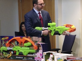 James Swartz, director of World Against Toys Causing Harm, or W.A.T.C.H., displays Nerf's "Zombie Strike" crossbow during a news conference Tuesday, Nov. 14, 2017, in Boston, where the child safety group released its annual holiday list of the 10 most hazardous toys. (AP Photo/Philip Marcelo)