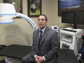 Dr. John DiMuro, Nevada's former chief state medical officer, talks to a reporter in his Reno medical office, Tuesday, Nov. 28, 2017, in Reno, Nevada. The anesthesiologist who has returned to private practice since he resigned Oct. 30 is defending the protocol he approved for the drugs scheduled to be used in Nevada's first execution in 11 years. (AP Photo/Scott Sonner)
