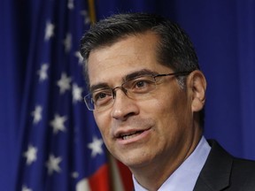 FILE - In this May 3, 2017, file photo, California Attorney General Xavier Becerra answers a question during a news conference in Sacramento, Calif. Becerra sued San Diego-based Ashford University on Wednesday, alleging the school and its parent company, Bridgeport Education Inc., used illegal business practices to deceive and defraud students. (AP Photo/Rich Pedroncelli, file)