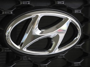 FILE - In this Oct. 26, 2017, file photo, the logo of Hyundai Motor Co. is seen on a car displayed at the automaker's showroom in Seoul, South Korea. Hyundai Motor Co. union spokesman Hong Jae-gwan said Tuesday, Nov. 28, 2017, that about 1,950 workers, or 4 percent of its union members, stopped work Monday at a plant in Ulsan, 380 kilometers (236 miles) southeast of Seoul. He said there was no plan to expand the partial strike into a full-blown one. (AP Photo/Lee Jin-man, File)