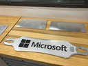 The Microsoft logo is seen next to magnesium slabs cut into pieces of prototype Surface hardware on a table in Building 87 at Microsoft Corp.’s headquarters in Redmond, Wash.