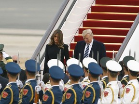U.S. President Donald Trump and first lady Melania Trump arrive on Air Force One in Beijing, China, Wednesday, Nov. 8, 2017. (Thomas Peter/Pool Photo via AP)