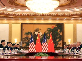 U.S. President Donald Trump, second right, and Chinese President Xi Jinping, left, attend a bilateral meeting at the Great Hall of the People in Beijing Thursday, Nov. 9, 2017.  (AP Photo/Andrew Harnik)