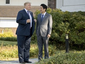 FILE - In this Nov. 5, 2017, file photo, U.S. President Donald Trump meets Japanese Prime Minister Shinzo Abe at Kasumigaseki Country Club, in Kawagoe, Japan. Some businesses in Asia are bracing for the unexpected as Trump traverses the region and meets with the leaders of major U.S. trading partners. Exporters are apprehensive, given Trump's penchant for unpredictability and vehement dislike for swollen U.S. trade deficits. (AP Photo/Andrew Harnik, File)