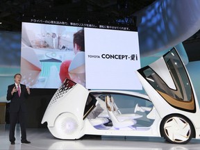 FILE - In this Oct. 25, 2017 file photo, Didier Leroy, executive vice president of Toyota Motor Corp., presents a Toyota Concept-i concept car during the media preview of the Tokyo Motor Show in Tokyo.  Toyota Motor Corp. is seeing a 16 percent gain in fiscal second quarter profit as sales grew, and a cheaper yen offset higher marketing costs. Toyota, Japan's top automaker, reported Tuesday, Nov. 7, 2017 its July-September profit totaled 458.2 billion yen ($4 billion), up from 393.7 billion yen the same period last year.(AP Photo/Eugene Hoshiko, File)