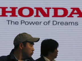 FILE - In this April 28, 2017, file photo, visitors walk through a showroom of the Honda Motor Co. headquarters in Tokyo. Japanese automaker Honda's fiscal second quarter profit has slipped compared to a year ago as costs related to a massive air-bag recall erased the perks of strong sales, Honda reported Wednesday, Nov. 1, 2017. (AP Photo/Koji Sasahara, File)